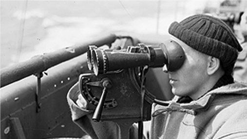 A man looking through binoculars.